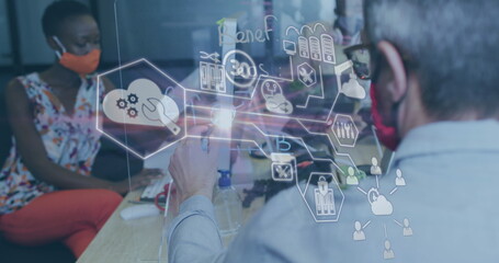 Image of financial data processing over diverse business people with face masks taking notes