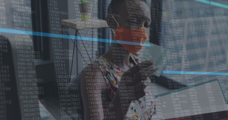 Image of financial data processing over businesswoman with face mask working in office