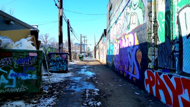 Graffiti covered alleyway in Denver's RiNo art district on a bright sunny winter day