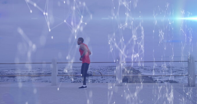 Image of network and processing data over male athlete with running blade training by the sea