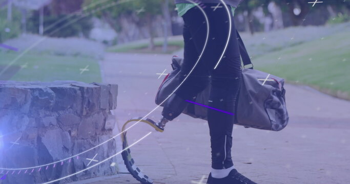 Image of scope and processing data over male athlete with running blade walking outdoors