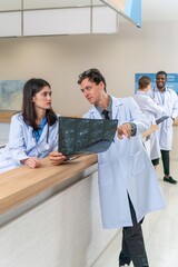 Doctors working together looking at a x-ray scan discussing solution and idea for a medical case in a hospital