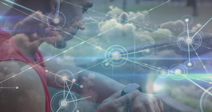 Image of glowing communication network over male athlete using smartwatch outdoors - Powered by Adobe