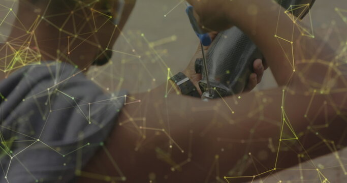 Image of yellow network over male athlete preparing prosthetic leg for exercising outdoors