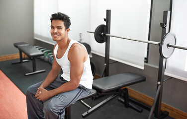 Weights, bench and portrait of man at gym with happiness for workout as body builder in Mexico. Healthy, person and smile after weightlifting exercise for strong muscle, fitness and training arms