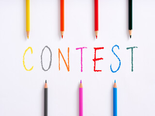 Handwritten word weekend and colorful crayons on white background.