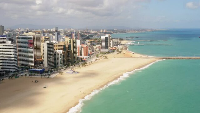 Aerial view of the buldings in front of the sea, the empty beach in a cloudy day, Fortaleza, Ceara, Brazil
