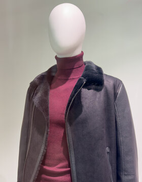 Male mannequin with clothes on display in a store