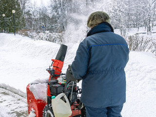 Gasoline snow plow for snow removal in winter. Clearing paths from snow cover for the convenience...