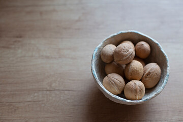 Nuts. Whole walnuts on a wooden kitchen table.