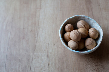 Fresh whole walnuts. Whole walnuts on a wooden kitchen table.