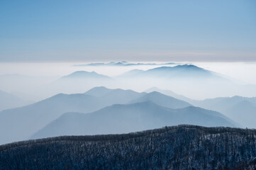 Early morning view of the mountains in the mist from the top of the mountain