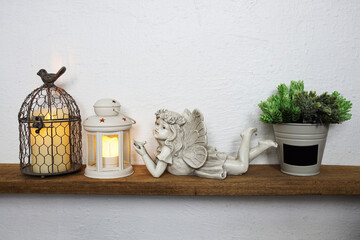 White lantern and Fairy statue Home decoration accessories on wooden shelves