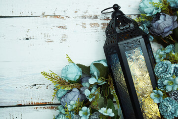 Black Moroccan Arabic lantern with flower on white table background