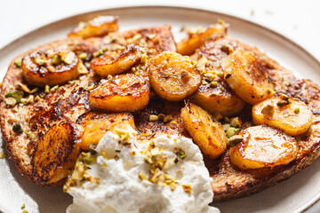 French toast with caramelized banana and pistachios.
