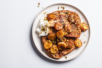 French toast with caramelized banana and pistachios.