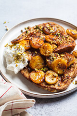 French toast with caramelized banana and pistachios.