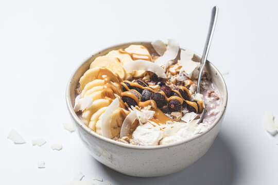 Overnight Oatmeal With Banana, Berries, Coconut Chips And Peanut Butter.