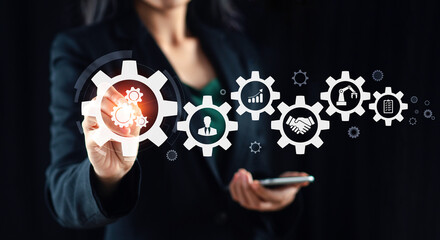 Digital industrial production automation concept Manager engineer taps automation icon on machine on modern virtual interface real time data in smart factory