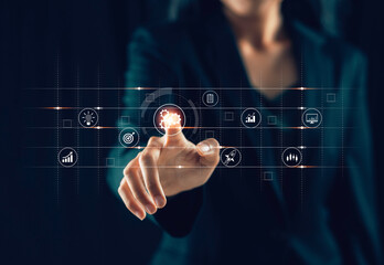 Businessman's hand touching the gear wheel icon shows a virtual screen. Concept of using automation technology To increase efficiency and effectiveness of marketing work of corporate businesses.