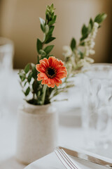 orange zinnia and summer foliage for wedding reception table