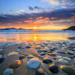 A magical sunset. Pebbles on the seashore. The surface of the beach on the north ocean