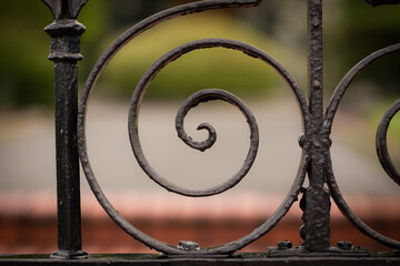 Curly black wrought iron fence up close