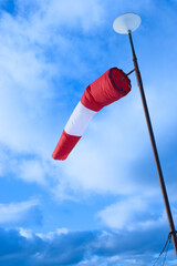 Windsock against beautiful blue sky with nice clouds