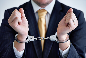 Hands, person in corporate and handcuffs for fraud or bribery, business deal gone wrong with...