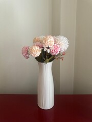 Artificial white and pink flowers in a white vase for flower arrangement, home decoration, social media post, print, ads, garden, spring, summer, floral background, wallpaper, backdrop, banner