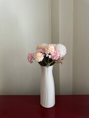 Artificial white and pink flowers in a white vase for flower arrangement, home decoration, social media post, print, ads, garden, spring, summer, floral background, wallpaper, backdrop, banner