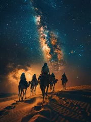 Fotobehang A Milky Way vista with a tribal caravan leading camels over a sand dune, captured in a blend of Documentary, Editorial, and Magazine Photography Style © akarawit