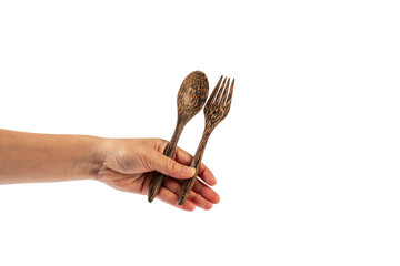 Wooden spoon and wooden fork in hand isolated on transparent background.