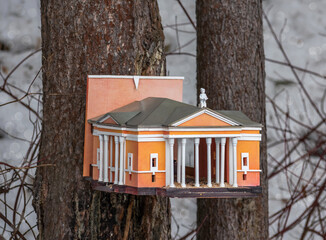 Bird feeder with bullfinches in the form of a theater model