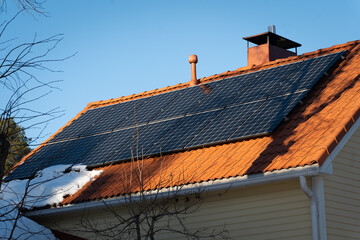 solar panels on top of home roof with snow