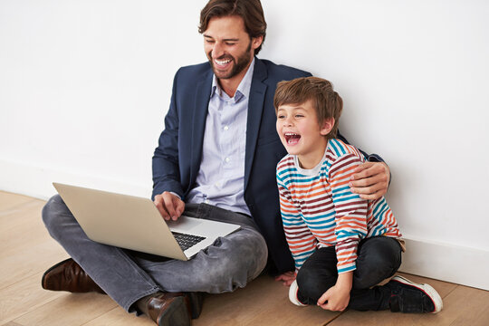 Father, child and laptop on floor for funny movie, game or parent reading meme with boy at home. Kid, dad and computer for comedy, laughing and family bonding together with technology on internet