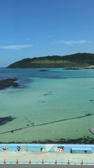 Fototapeta premium Turquoise Lagoon with Pristine Waters and Scenic Hills