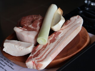 Fresh Pork Belly and Vegetables on Wooden Plate