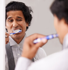 Businessman, face and brushing teeth in mirror for morning routine, hygiene or cleanliness at home....