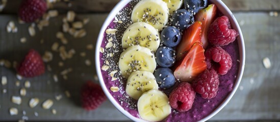 A delicious bowl of smoothie made with natural foods including bananas, blueberries, raspberries,...