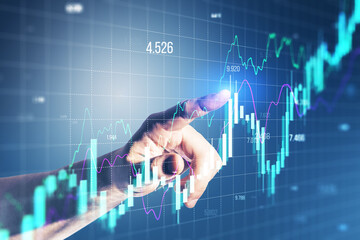 Close up of male hand pointing at growing forex chart on blurry background. Financial investment...