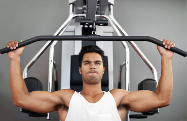 Fitness, pull down machine and man in studio on gray background for training or workout at gym....