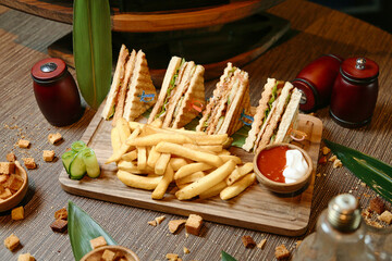 Wooden Cutting Board With Half Sandwich and French Fries