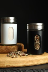 Salt and pepper shakers on table against black background