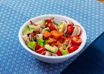 Poke with salmon, avocado, tomato, onion. Asia food.
