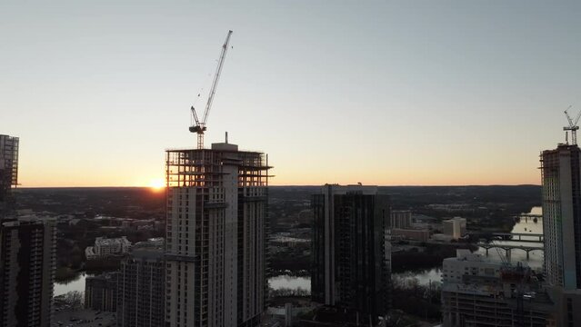 Aerial shot of cranes in construction site building high-riser apartments and offices