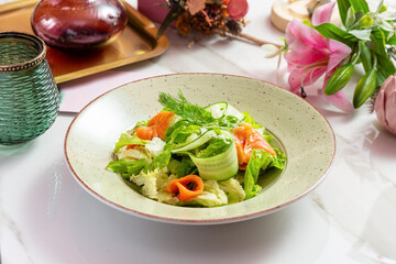 Salad with salmon, cucumber and lettuce. Lunch.