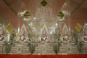 Silver Buddhas on row at Antique glass cathedral and modern buddha for Thai people travel visit...