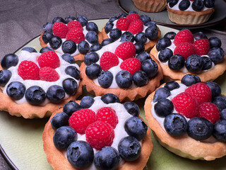 Freshly baked baskets with curd cream and strawberries	