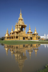 Wat Rong Khun (White Temple) in Chiang Rai city, Thailand. Religious traditional national Thai architecture. Landmark, view, sight, attraction, architectural monument of Chiang Rai town, Thailand